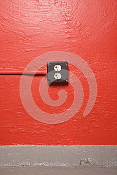 Wall with electrical outlet.