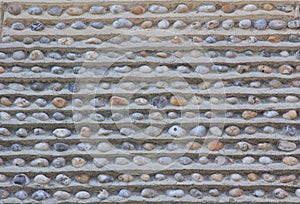 Wall with embedded pebble stones