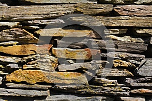 Wall.  Fence.  A rock.  Stone wall.  Gray.  Brown.  Background.  Wallpaper.  Design. Stones. Fragment.