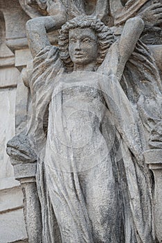 Wall figure of beautiful woman holding a big wreath at historical museum in Magdeburg, Germany