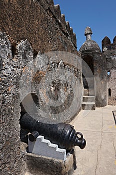 Wall of Fort Jesus in Mombasa with cannon placed in a loophole