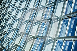 Wall and glass ceiling of the modern office building, blue abstract background