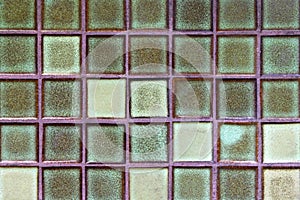 Wall from glass squares green color for background.