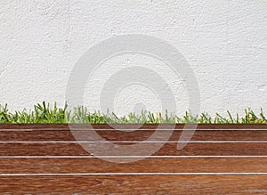 Wall and green grass on wood floor