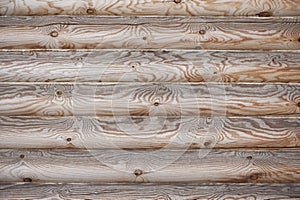 Wall of hewn logs with natural wood pattern