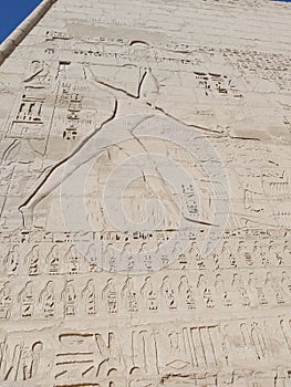 Wall with hieroglyphic carvings at ancient Egyptian temple of Medinat Habu in Luxor
