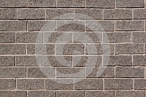 The wall of the house is lined with gray bricks. Used as a background.