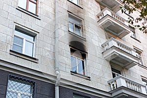 The wall of the house is stained with soot after the fire.