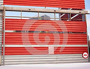 The wall of industrial building with a sliding gate. winter view