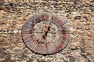 Wall of the Kaptol fortress and the Antique rusty clock removed from the Zagreb Cathedral