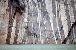 The wall and lagoon of a Tower of Paine at the Torres del Paine National Park, Chilean Patagonia, Chile