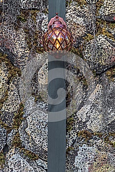 Wall lantern on stone with lights