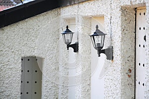 Wall lanterns on old house, perspective view