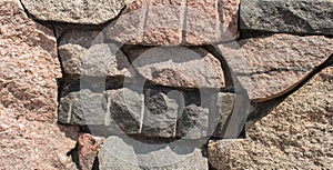 A wall of large granite uncut stones
