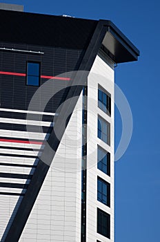 A wall with a lot of square glass windows on the building. The rhythm of the windows. Geometric pattern