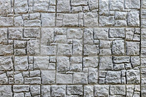Wall made of artificial stone. Finishing the facade of the building. Texture
