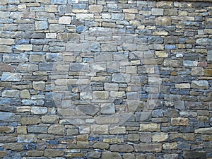 Wall made of blue and grey gray stone blocks. Suitable for background or wallpaper. Brickwork.