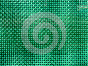 Wall made of decorative metal mesh coated with green polymer. background