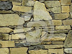 Wall made of grey gray stone blocks. Suitable for background or wallpaper. Brickwork. Stone wall cladding.