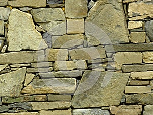 Wall made of grey gray stone blocks. Suitable for background or wallpaper. Brickwork. Stone wall cladding.