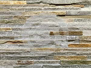 Wall made of grey oblong shape rocks photo