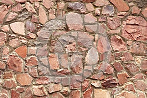 The wall is made of natural raw coarse red granite