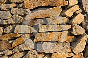 Wall made of natural stone in the evening sun