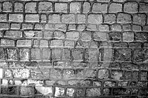 Wall made of old stones in black and white