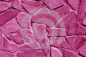 Wall made of old stones in pink tone