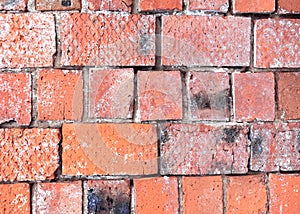 The wall is made of red burnt brick