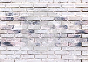 Wall is made of white ceramic decorative interior bricks with scorch marks