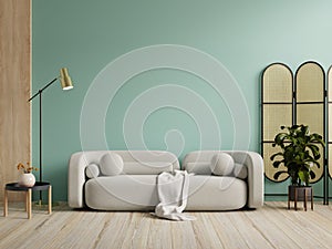 Wall mockup in green color with gray sofa and decor in living room