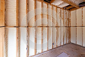 Wall in new home under construction, with spray foam insulation