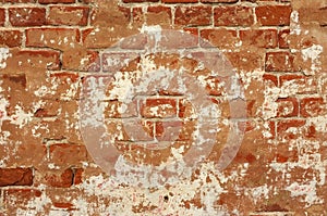 Wall of old concrete and red weathered bricks. Old brick wall. Plaster background grunge texture