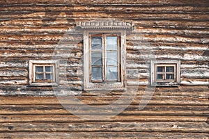 Wall of an old farm building. Natural wooden texture, rural house for agritourism, different windows, country house