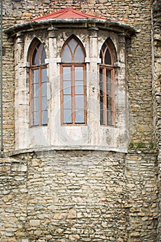 Wall of old medieval castle, detail with ghotic windows