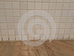 Wall with old and white tiles, rustic floor