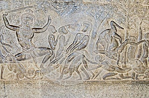 The wall of one of the galleries of Angkor Wat showing episodes from the Hindu epics photo