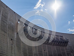 Wall, overflow and sun at impressive Katse Dam hydroelectric power plant in Lesotho, Africa