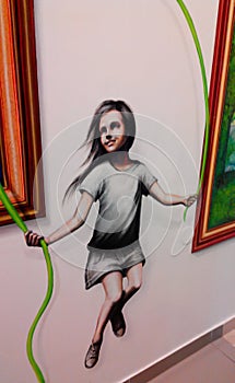 On the wall is a painted figure of a girl jumping rope