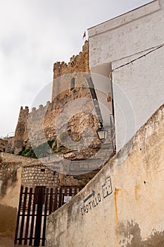 On the wall painted postsign leading visitors to the castle of AlcalÃ¡ del JÃºcar, Castilla la Mancha, Spain photo