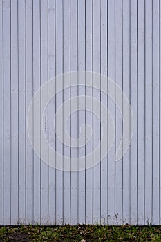 Wall painted white with dark stripes in the joints of the boards