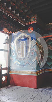 Wall paintings and prayer bell near the window inside the Punakha Dzong dating from 1637, Punakha, Bhutan