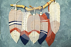 Wall panel in Boho style made of cotton beige, blue and red cords using macrame technique