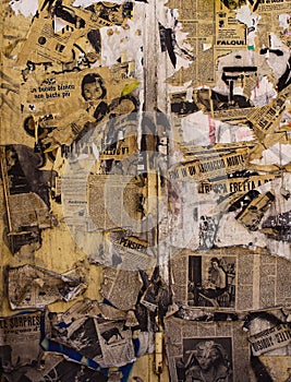 Wall papered with torn and old newspapers