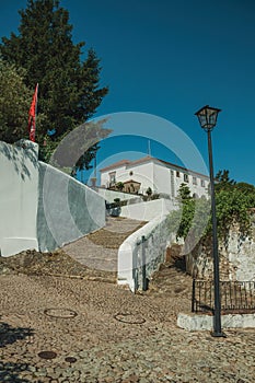 Wall and pathway made of stone with large stairs going uphill