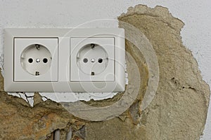 Wall plaster loosens around sockets