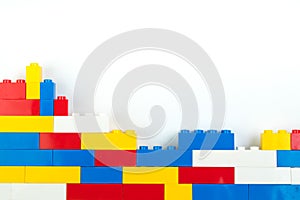 Wall from Plastic building blocks isolated on white background. Top view with copy space.