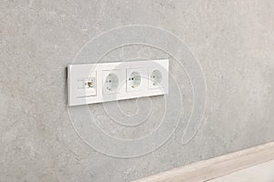 Wall with power outlet sockets in room. Interior design