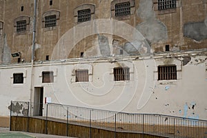 Wall of prison building with windows of pricon cells
